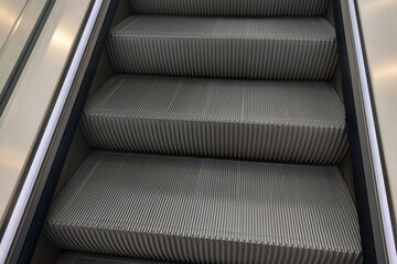 Close-up of the metal steps of the elevator in the shopping center.