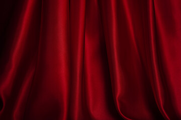 Bright red curtains are beautifully wavy, close-up.