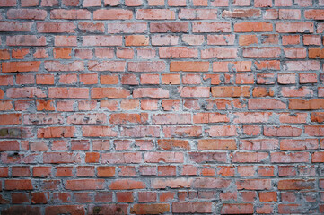 Red brick wall. City buildings. Brick background. Repair, construction. Weathered stained old brick wall background.