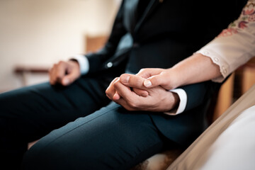Love is in the air, young couple is holding hands, detail on rings,wedding day