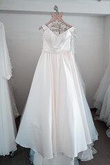 Fototapeta na wymiar Wedding dresses in the shop waiting for brides