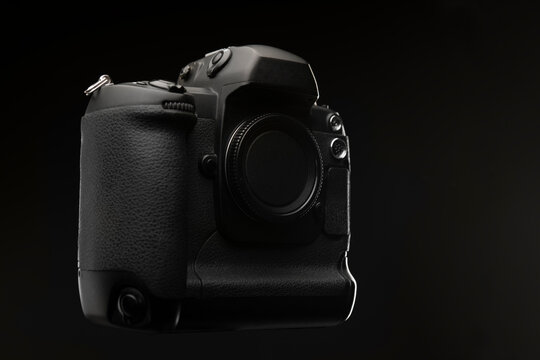 Professional digital single lens reflex camera over black background
