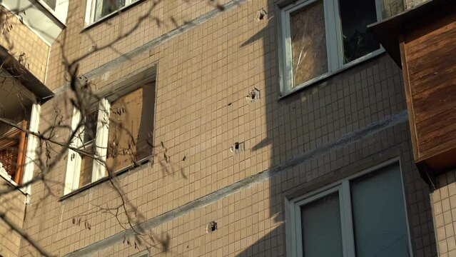 Consequences of rocket attack on the center of Ukraine. Funnel from a drone explosion. Attack of Iranian Shahed 136 drones on Kyiv. Damaged residential building. Broken windows and holes from debris.