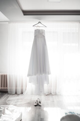 Fototapeta na wymiar Beautiful wedding dresses and shoes are waiting for bride, wedding day,love