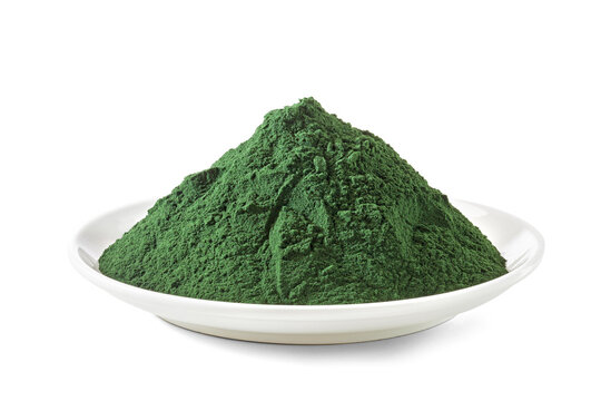spirulina chlorella algae powder in a dish isolated on white background.