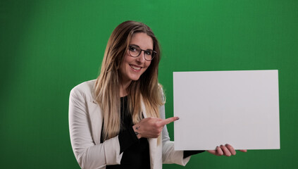 Young pretty woman holds a dummy sign and points to it - studio photography