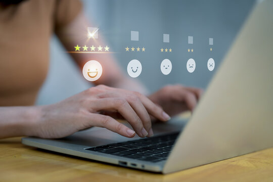  Customer service and Satisfaction concept ,Business people are touching the virtual screen on the happy Smiley face icon to give satisfaction in service. rating very impressed.