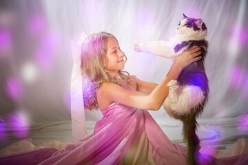 Portrait of cute kid girl posing in pink beautiful dress on a white background. Model in studio looking as gentle magic princess from fairy taly
