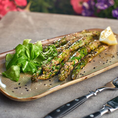Grilled asparagus with peanut sauce on a plate. selective focus