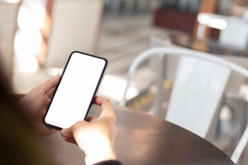 cell phone blank white screen mockup.hand holding texting using mobile on desk at office.background empty space for advertise.work people contact marketing business,technology