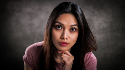 Happy girl against a grey background - studio photography