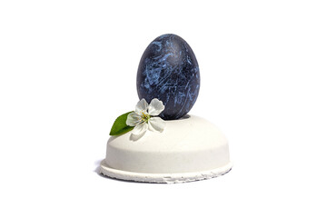 Easter egg on a beton stand isolated on white background. Traditional symbol, blooming cherry