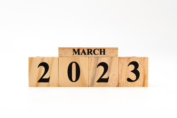 March 2023 written on wooden blocks isolated on white background with copy space