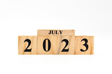July 2023 written on wooden blocks isolated on white background with copy space