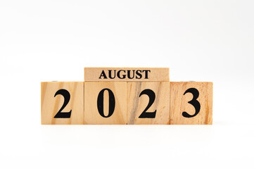 August 2023 written on wooden blocks isolated on white background with copy space