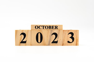 October 2023 written on wooden blocks isolated on white background with copy space