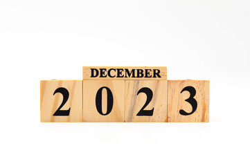 December 2023 written on wooden blocks isolated on white background with copy space