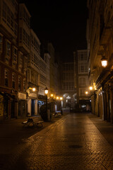 Pedestrian narrow street at night. Lights are on and there are no people, loneliness.