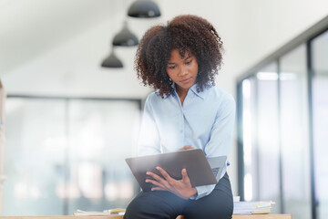 Financial advisor, corporate accountant and african woman in office. analyzing benefits, enjoying...
