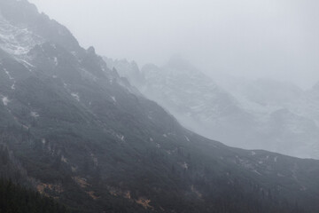 mountains in the fog and snow