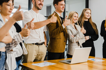 Motivated successful business team, group of business people  show thumb up