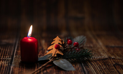 Candle for the 1st Advent and Christmas. Decoration with red Advent candle, fir branches, cones,...