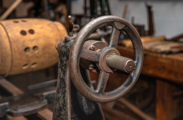 Used hand wheel from an unknown old machine. The handwheel is mounted on a threaded shaft.