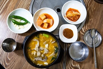 Boiled beef intestines, japchae, soybean paste, vegetables, and green onions in an earthen pot, Korean traditional food,
