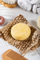 Eco friendly solid shampoo bar and natural bathroom accessories lying on a Honeycomb Paper, white...