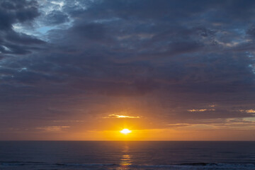Fototapeta na wymiar Colorful sunrise, with clouds, over the sea
