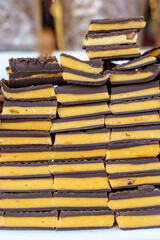 Chocolate on the showcase of a confectionery shop. Milk chocolate with fruit filling. Sweets, sugar background