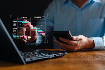 Project manager working on tablet and updating tasks and milestones progress planning with Gantt chart scheduling interface for company on virtual screen. Business Project Management System.