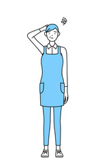 困って頭をかくエプロンを着たシニア女性