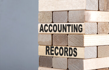 The text on the wooden blocks ACCOUNTING RECORDS