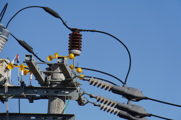 close up of electric power transmission line during the day. High voltage switchgear and power generation equipment.	
