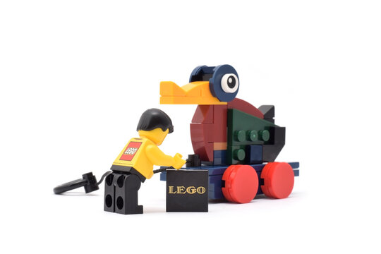 Lego historical toy duck vehicle made from plastic bricks in retro style isolated on white. Editorial illustrative image of 90 years of popular brand of children toys.