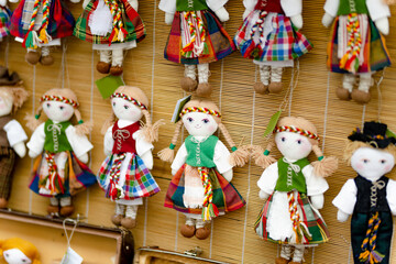 Cute handmade ragdoll dolls in Lithuanian national costumes sold on Easter market in Vilnius.