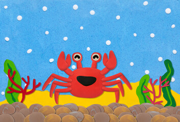 red crab made from plasticine on  under water background