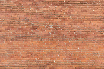 Background graphic resource brick wall with gaps in the pointing, heavily textured brick, horizontal aspect
