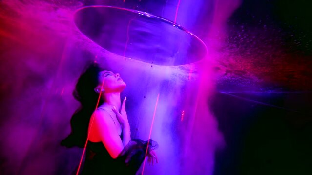 mysterious seductive underwater shot with beautiful young brunette woman in black lingerie