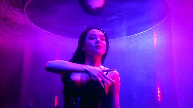 sexy lady swimming in depth with fabulous purple lights, art underwater shot, slow motion