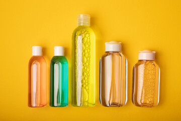 Micellar water on a bright yellow background. Makeup and sebum removal toner. Tonic, serum or lotion. Skin care. Beauty concept.FLETLEY.Top view. Place for text. copy space