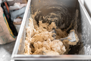 A kneading machine is mixing the corn dough to prepare tortillas in Mexico