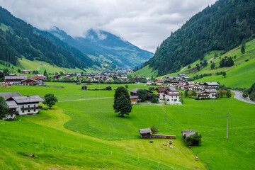 Fototapeta na wymiar The valley Grossarltal known as the “valley of alpine pastures” in the Hohe Tauern National Park, Austria. Beautiful green alpine valley on a cloudy summer day.