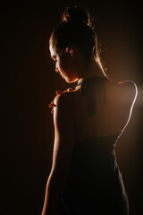 Pose of fashion girl holding her shoulder. Studio shoot