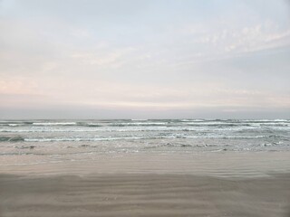 Sandy ocean beach at sunset