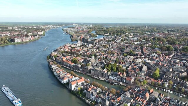 Aerial of the Oude Maas river in Dordrecht. Urban city overhead aerial view. Vessels boats sailing over the river. The Netherlands.