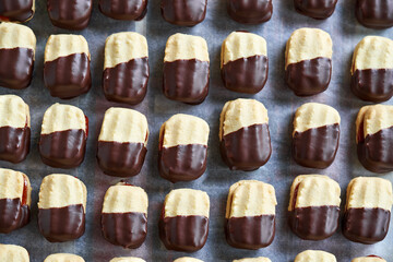 Homemade Christmas cookies filled with marmalade and dipped in chocolate