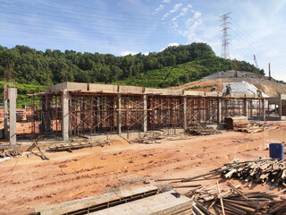 MELAKA, MALAYSIA -JUNE 19, 2022: A view of a construction site in full swing. Machines and workers are busy doing work. The safety level is ensured to reach the required standards.