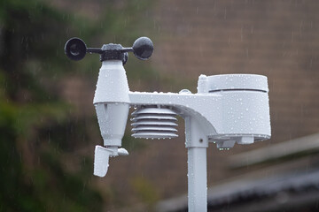 Weather station measuring temperature, humidity, precipitation, wind speed and direction